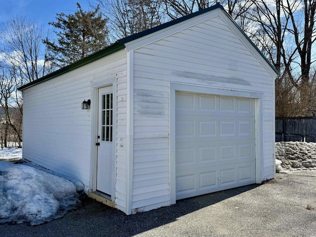 detached garage featuring fence