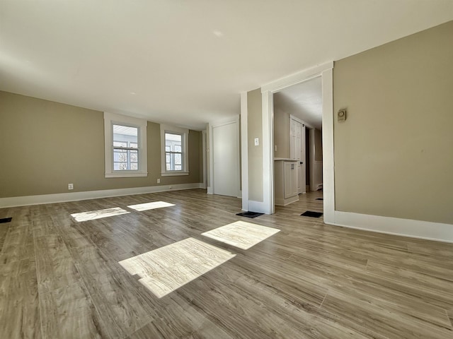 empty room with wood finished floors and baseboards