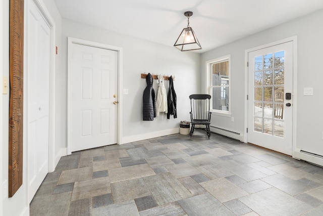 entryway with stone finish flooring, baseboards, and a baseboard radiator