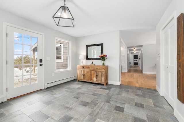 doorway to outside featuring a baseboard radiator, baseboards, and stone finish floor