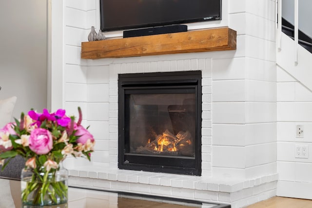 details featuring a brick fireplace