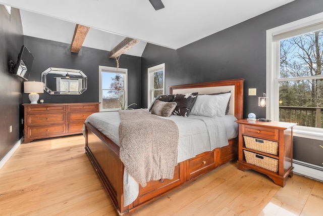 bedroom with a ceiling fan, light wood-style flooring, baseboards, and beamed ceiling