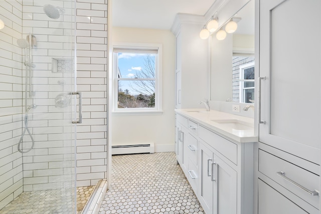 bathroom with a sink, a shower stall, and a baseboard radiator