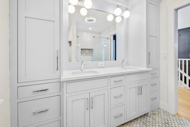 full bath with double vanity, tile patterned flooring, a shower stall, and a sink