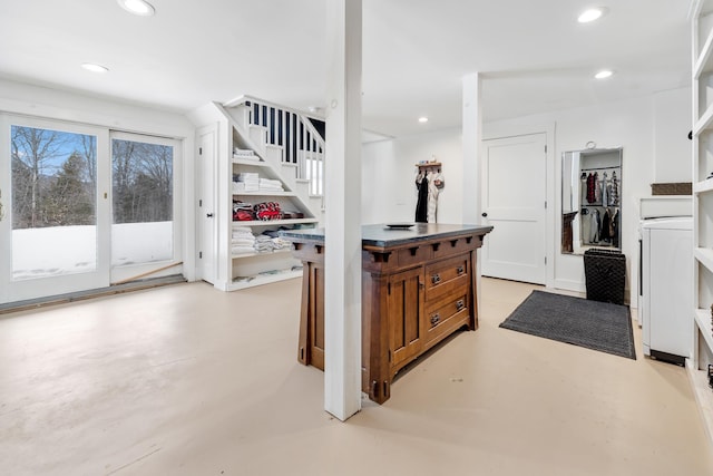 kitchen featuring brown cabinetry, recessed lighting, and finished concrete floors