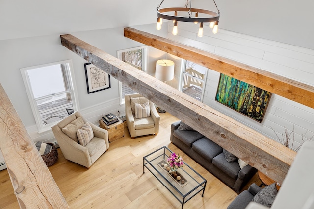 living area with vaulted ceiling and wood finished floors