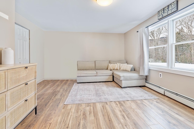 unfurnished living room featuring light wood-style flooring, baseboards, and baseboard heating