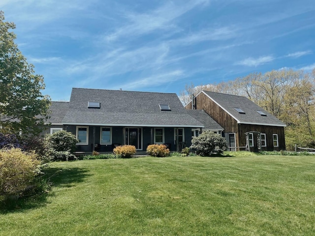 back of house featuring a porch and a yard