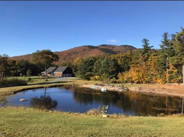 view of water feature with a mountain view and a wooded view