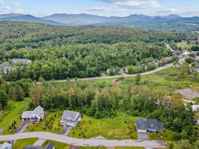 drone / aerial view with a mountain view and a forest view