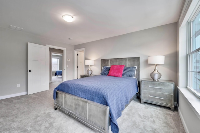 carpeted bedroom featuring baseboards