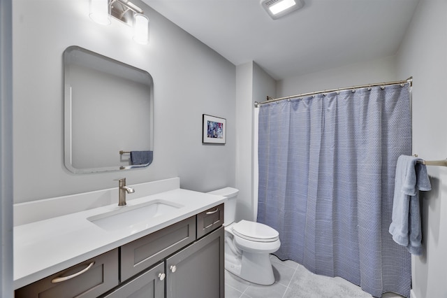 bathroom with tile patterned flooring, curtained shower, toilet, and vanity