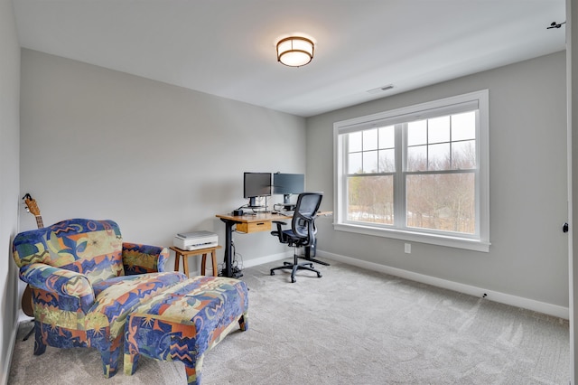 carpeted office featuring visible vents and baseboards