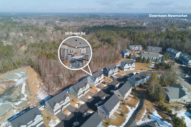 bird's eye view featuring a wooded view and a residential view