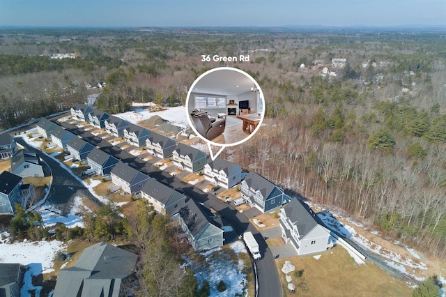 bird's eye view featuring a residential view and a wooded view