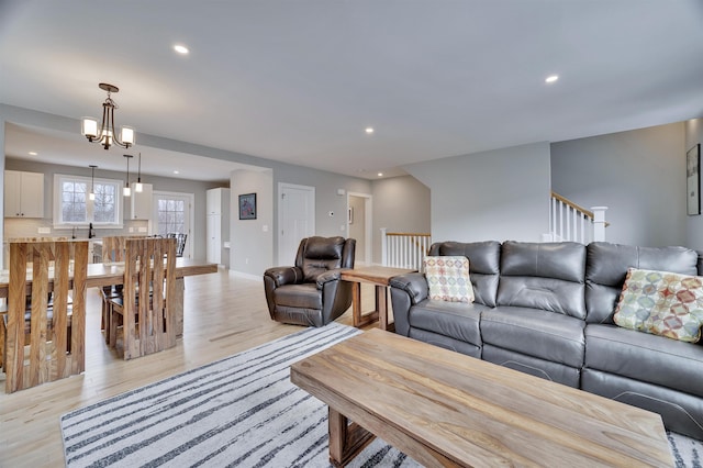 living area with a notable chandelier, recessed lighting, baseboards, and light wood finished floors