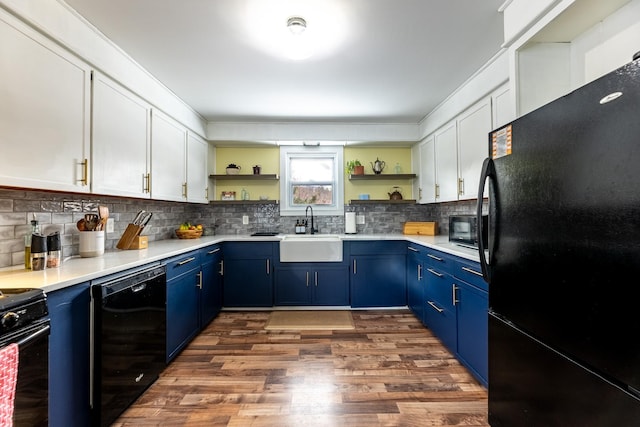 kitchen featuring black appliances, blue cabinets, open shelves, and a sink