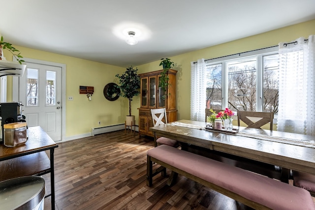 dining room with baseboards, dark wood-style flooring, a wealth of natural light, and a baseboard radiator