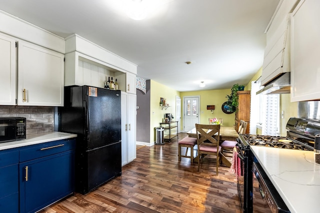 kitchen featuring tasteful backsplash, blue cabinetry, dark wood finished floors, white cabinets, and black appliances