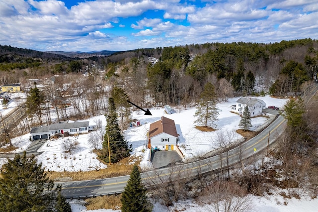 snowy aerial view featuring a view of trees