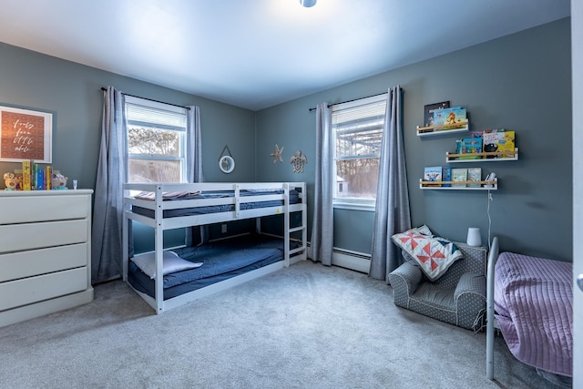 carpeted bedroom featuring a baseboard heating unit and multiple windows