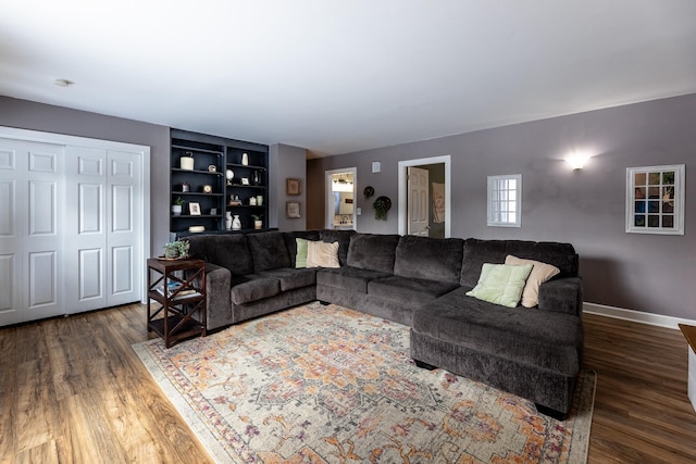 living room with baseboards and wood finished floors