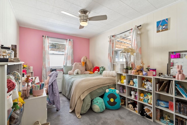 carpeted bedroom with ceiling fan and ornamental molding