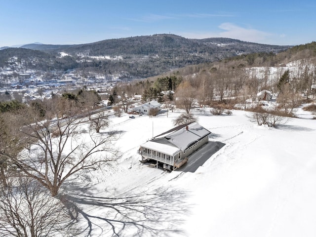 snowy aerial view with a mountain view