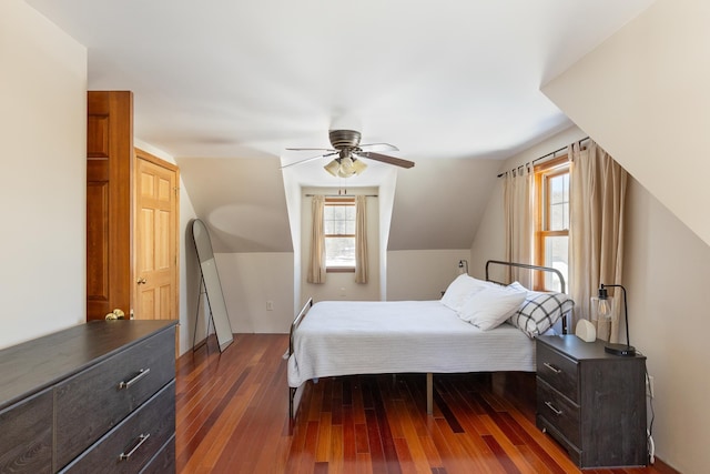 bedroom with lofted ceiling, multiple windows, dark wood-style floors, and ceiling fan