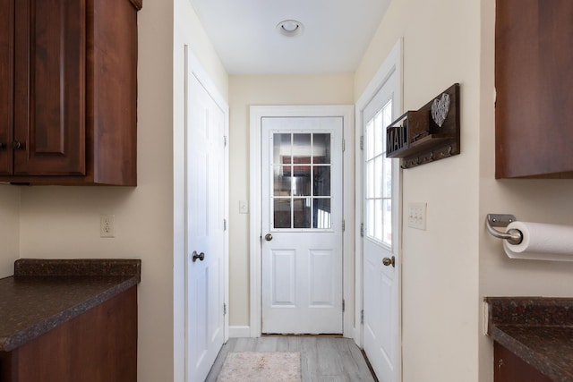 doorway to outside with light wood-style floors