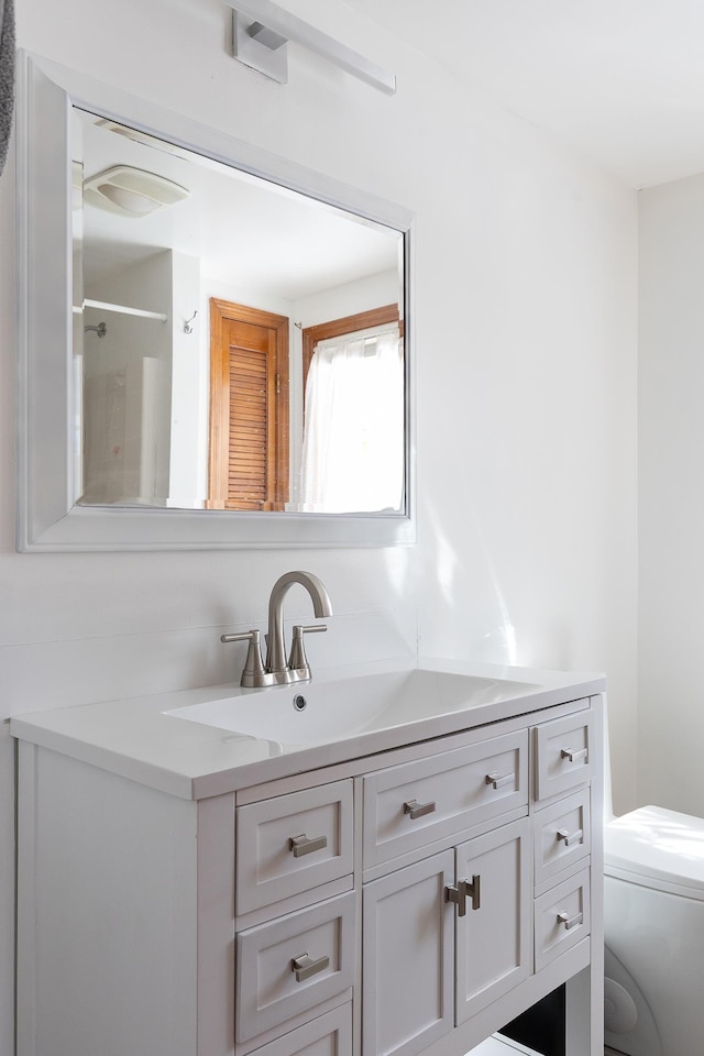 bathroom with vanity and toilet