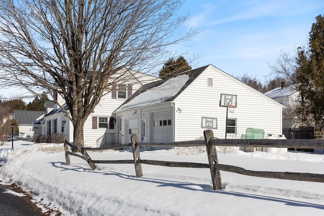 view of front of house with an attached garage and fence