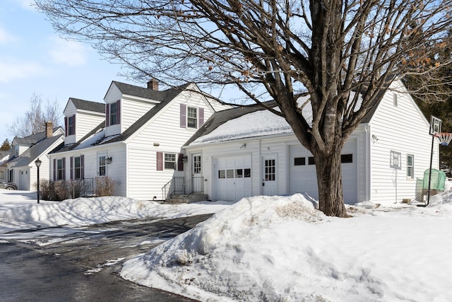 view of front of home with a garage and a chimney