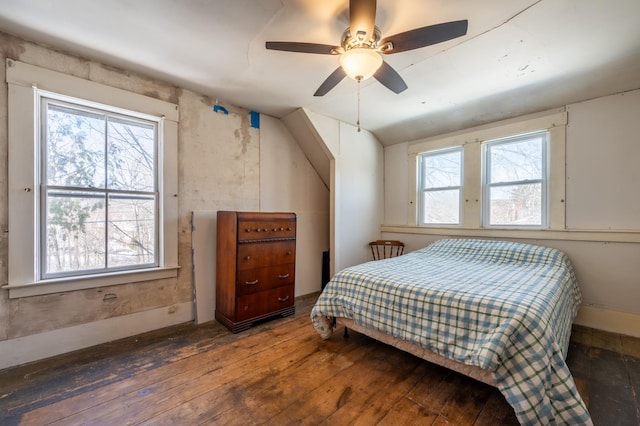 bedroom with multiple windows, ceiling fan, lofted ceiling, and hardwood / wood-style floors