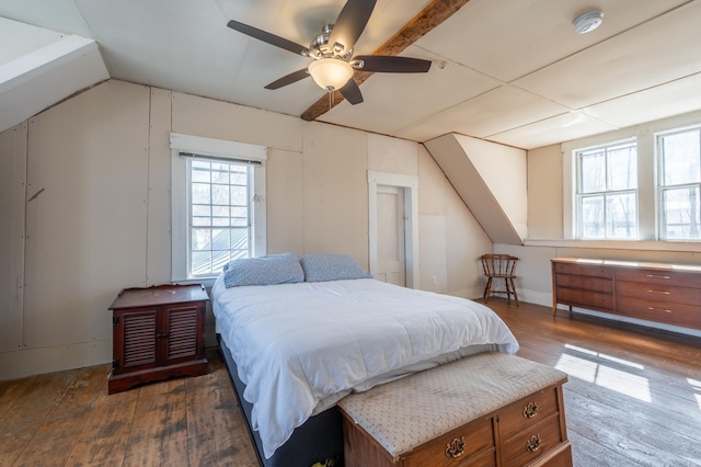 bedroom with vaulted ceiling, a ceiling fan, and wood-type flooring