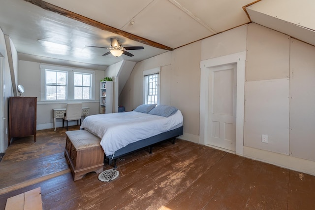 bedroom featuring lofted ceiling with beams, multiple windows, and hardwood / wood-style floors