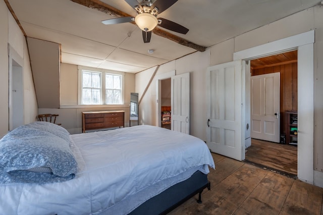 bedroom with wood walls, ceiling fan, and hardwood / wood-style floors