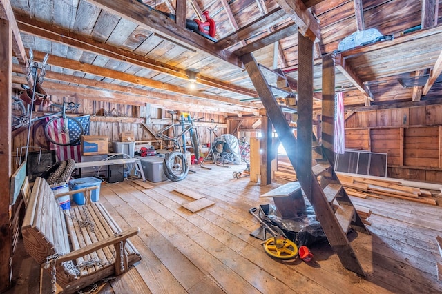 interior space with a garage, wood-type flooring, wooden walls, and wooden ceiling