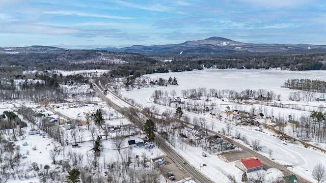 snowy aerial view with a mountain view