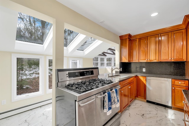 kitchen featuring a baseboard radiator, a sink, appliances with stainless steel finishes, marble finish floor, and backsplash