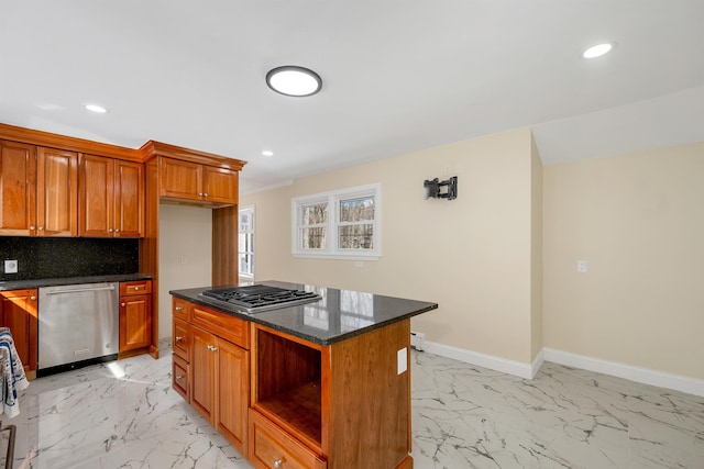 kitchen with tasteful backsplash, baseboards, marble finish floor, and stainless steel appliances