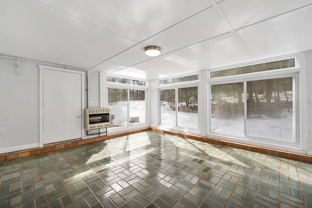 unfurnished sunroom with heating unit