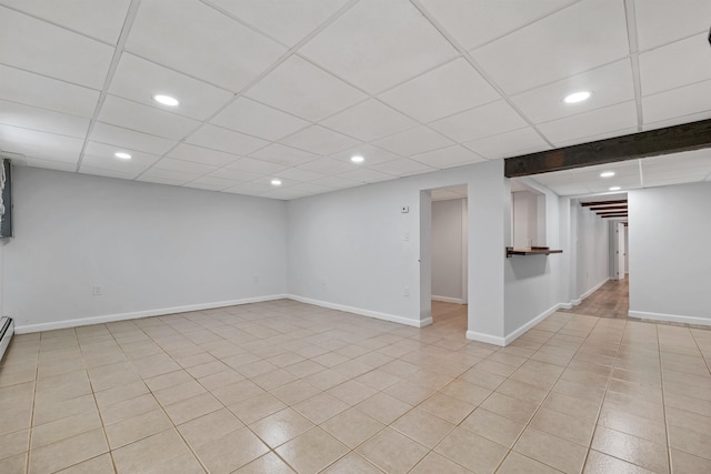 finished below grade area featuring recessed lighting, a paneled ceiling, and baseboards