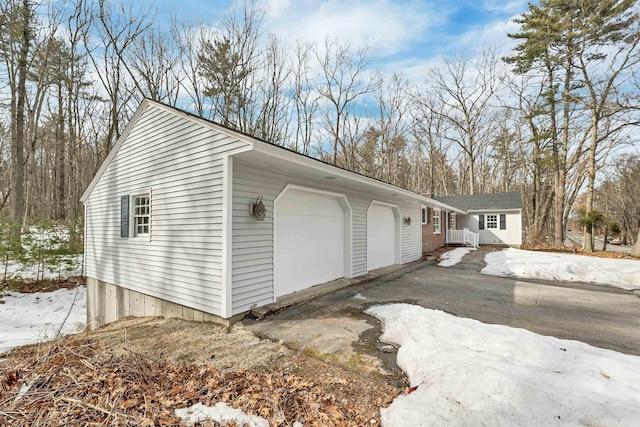 garage with aphalt driveway