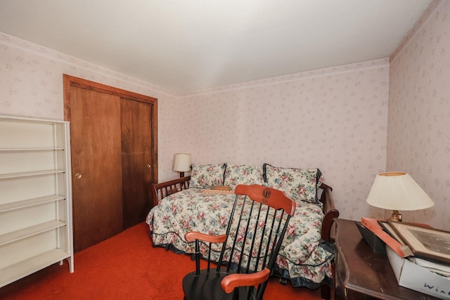 carpeted bedroom with a closet and wallpapered walls