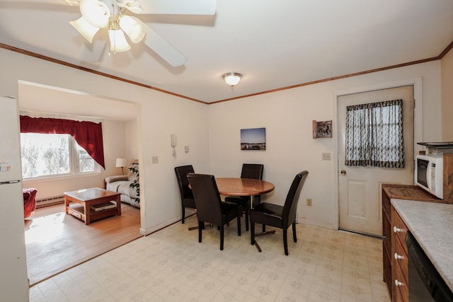 dining space featuring a baseboard heating unit, baseboards, light floors, and ornamental molding