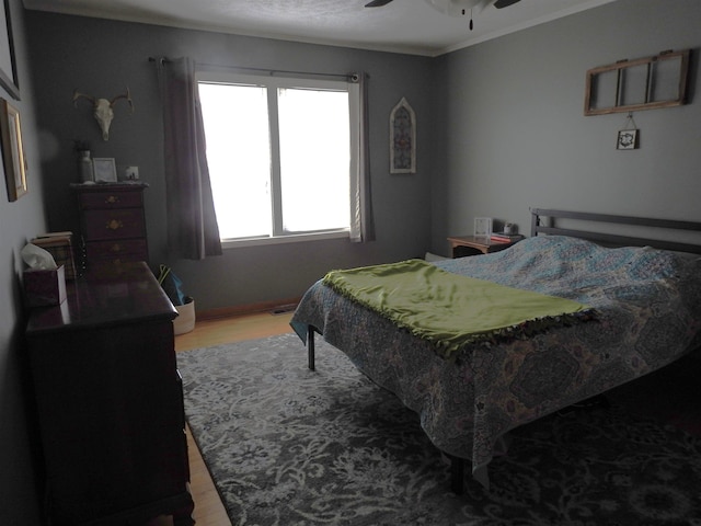 bedroom featuring ceiling fan and wood finished floors