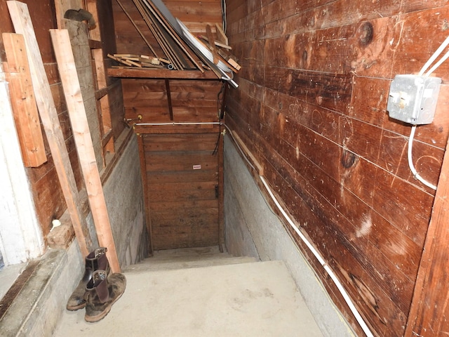 stairs featuring wooden walls