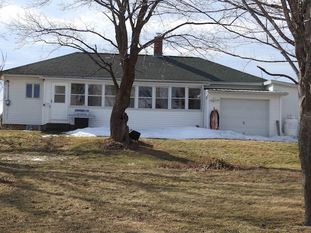 ranch-style home featuring a front yard, roof with shingles, an attached garage, a chimney, and entry steps