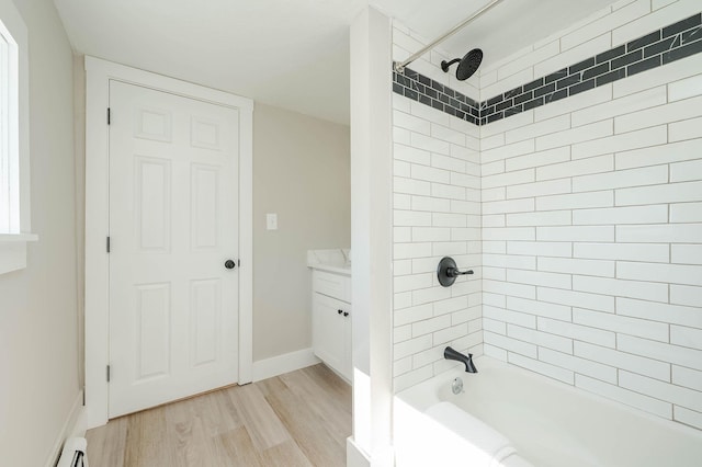 full bathroom with vanity, wood finished floors, baseboards, bathtub / shower combination, and a baseboard heating unit